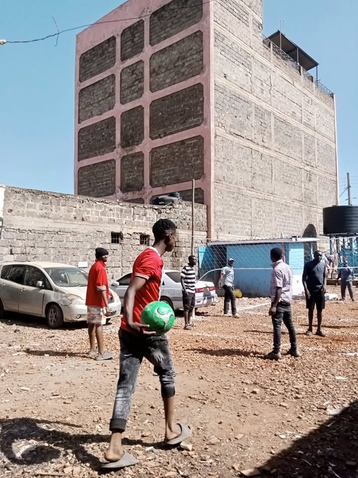 Youth playing football in the yard