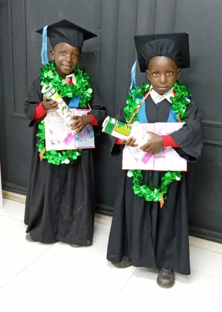 Two of the youngest graduates in cap and gown