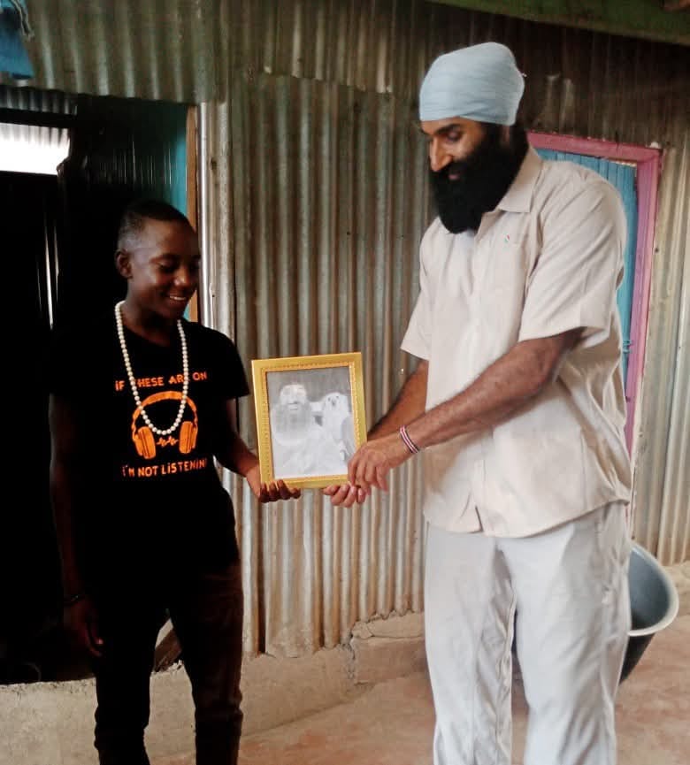 A visitor and a resident share a moment with a framed keepsake