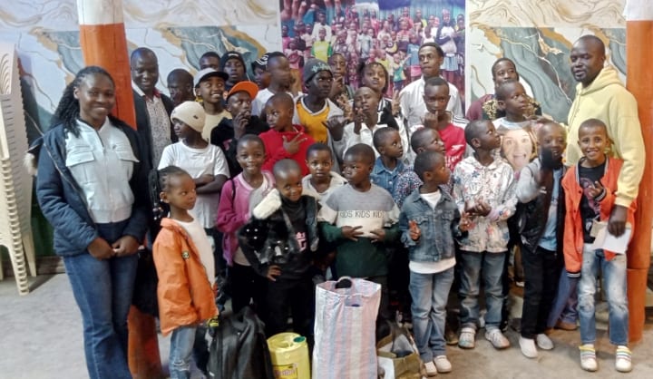 A group photo with friends of the centre indoors