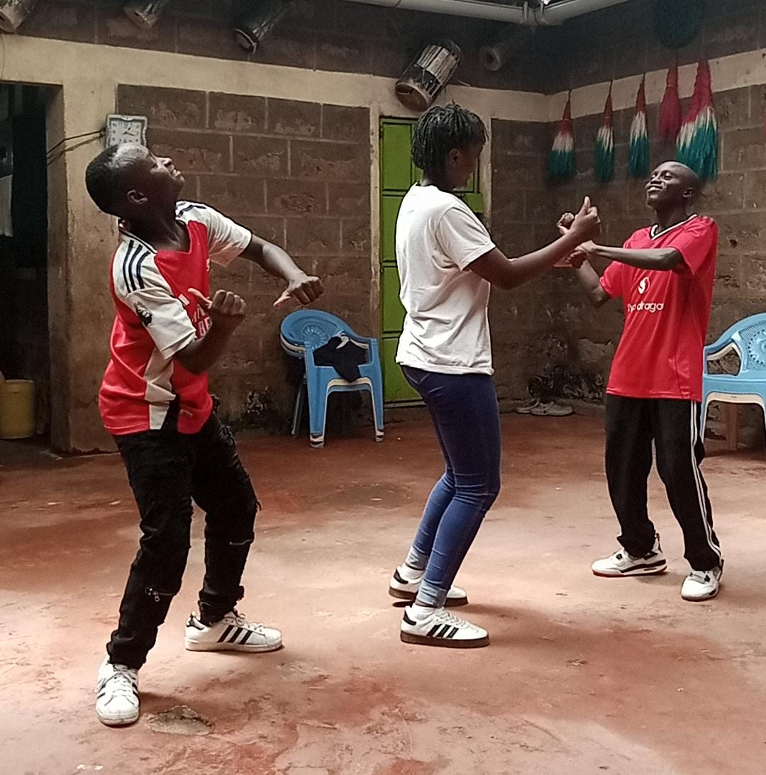 Practicing dance moves together in the community hall