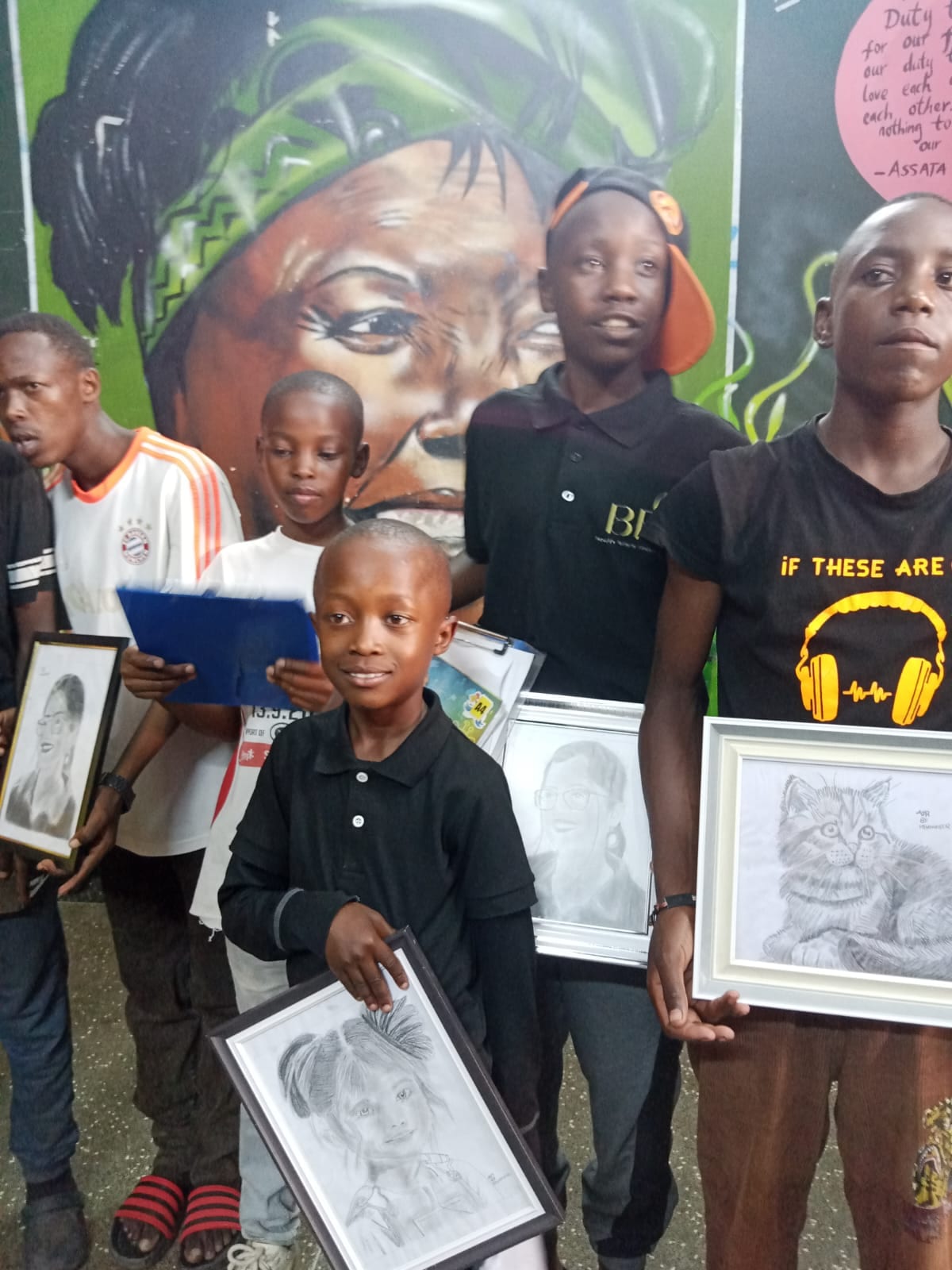 Proud young artists with their pencil portraits