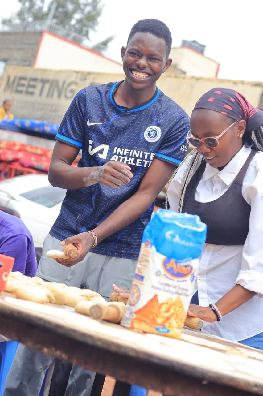 A young man smiling at a community feeding day