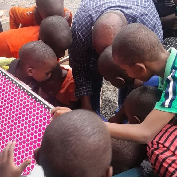 Children gathered around, curious and engaged