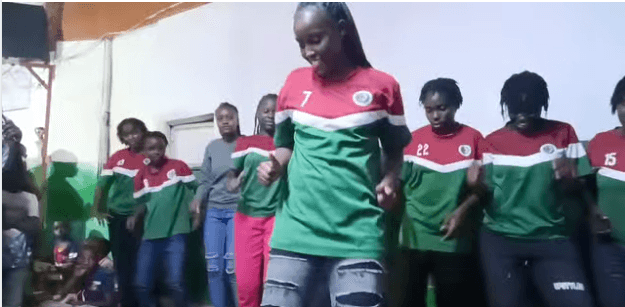 A young performer dancing on stage in team colours