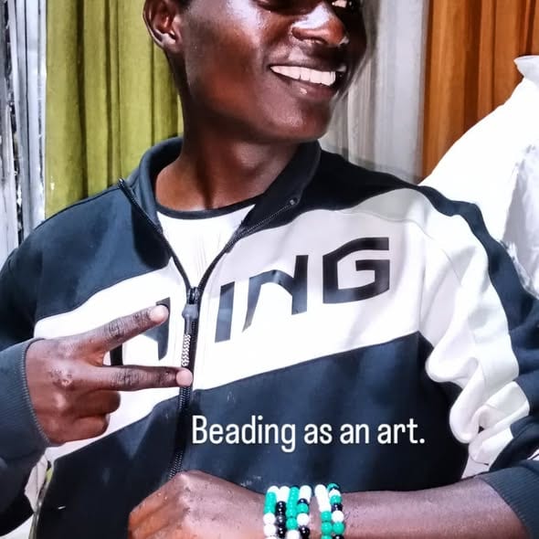 A young person wearing handmade beaded bracelets