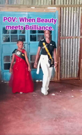 A young king and queen of the centre in sashes