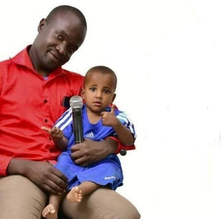 Samuel Barasa, founder of The Grace Community Centre, holding a young child